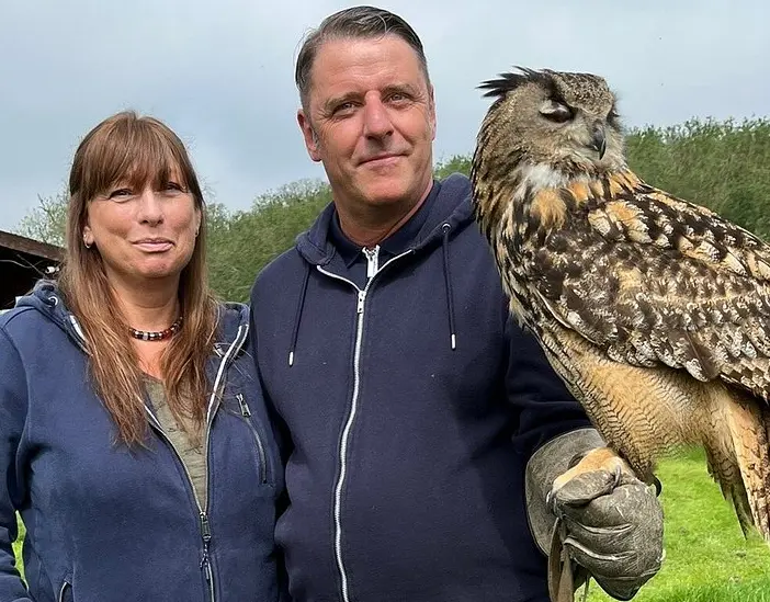 alders Zofia and Juliet the barn owl on a falconry experience london A group of visitors on a Falconry experience holding a Siberian eagle owl and a Harris Hawk