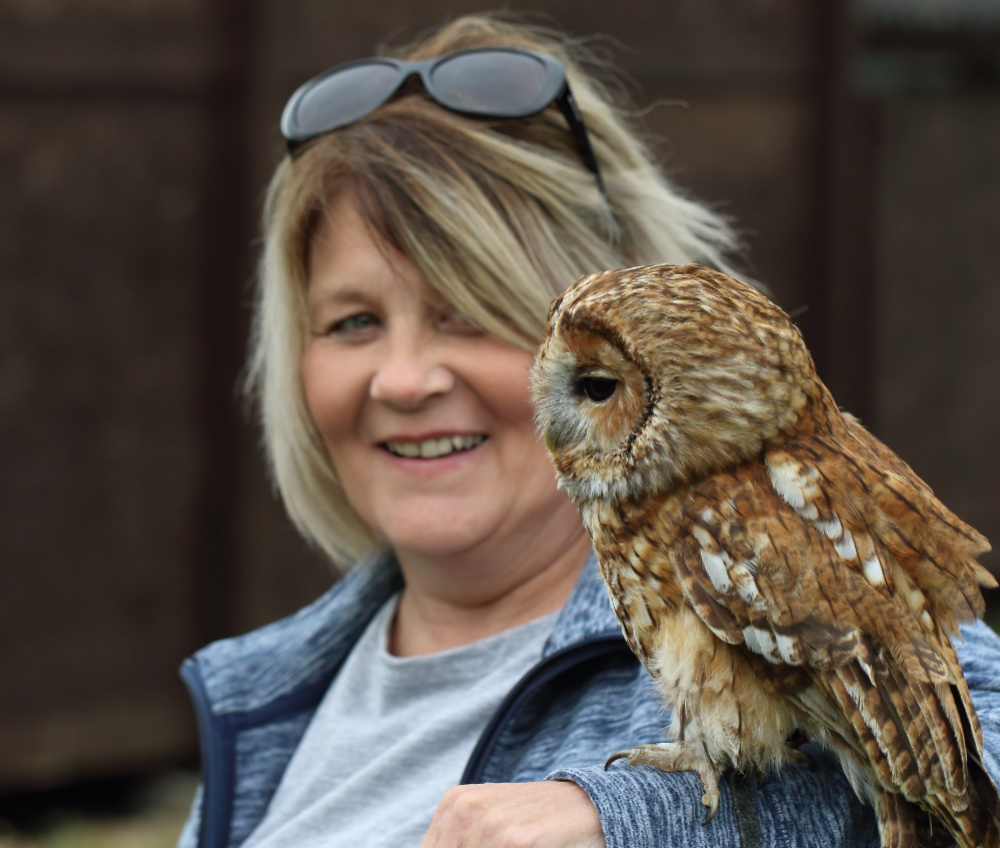 Fletcher the tawny owl on a woman's arm