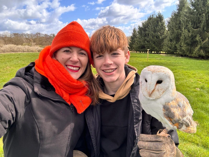 Jen and Jason Holding a barn owl on the fist on their Meet The Owls experience.