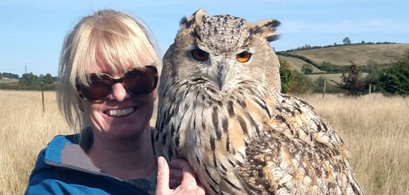 Woman holding priscilla siberian eagle owl