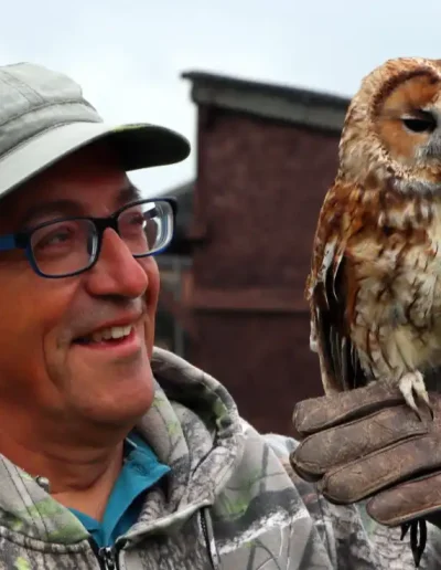 a man holding an owl on a falconry experience day at bird on the hand